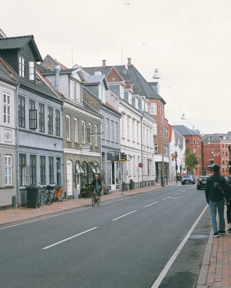 Gade i det centrale Odense med lave, lyse byhuse langs fortovet